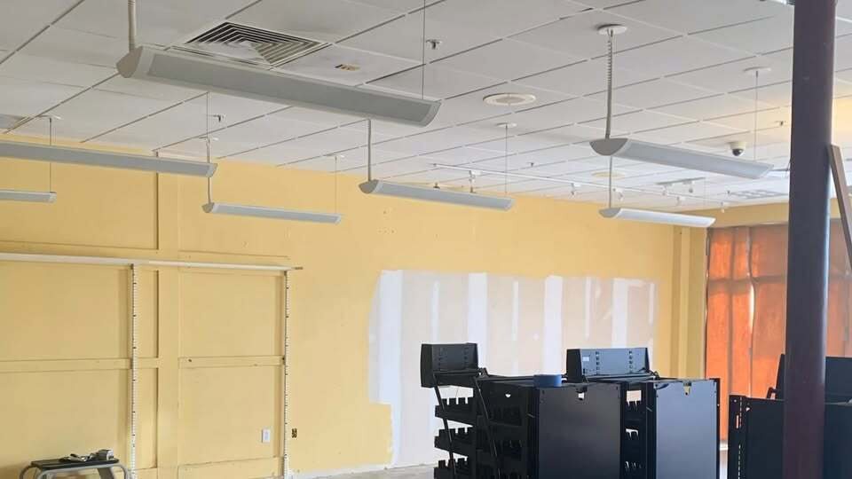 Commercial interior with drop ceiling and drywall patching in progress